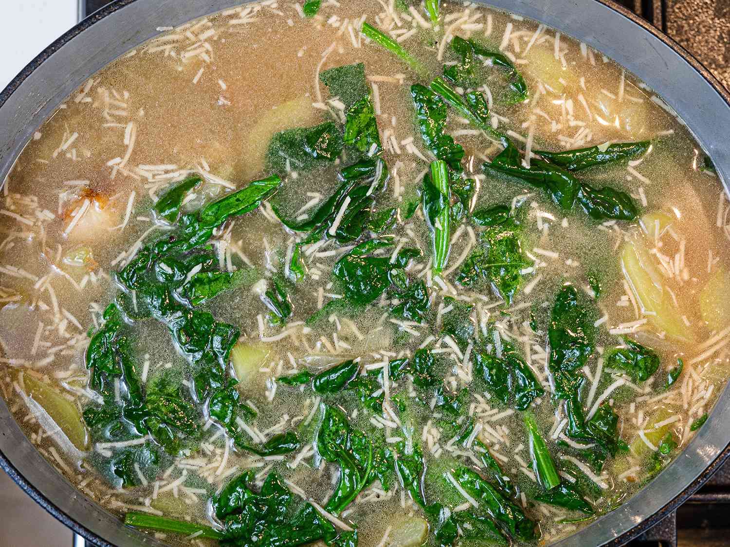 Spinach added to simmering binakol.