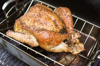 A whole roasted chicken in the Cuisinart roasting pan.