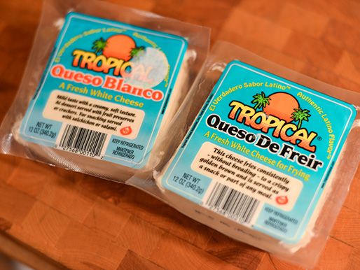 One package of queso blanco and one package of queso de freir on a cutting block