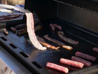 flipping bacon on the griddle