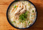 Overhead view of homemade dak juk, a comforting Korean rice porridge.