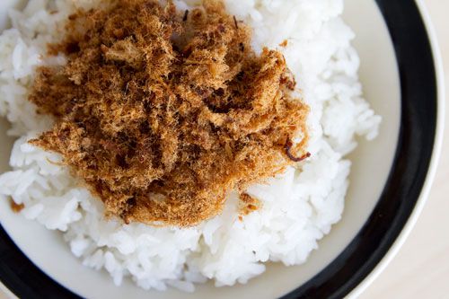Pork floss resting on a bed of white rice. 