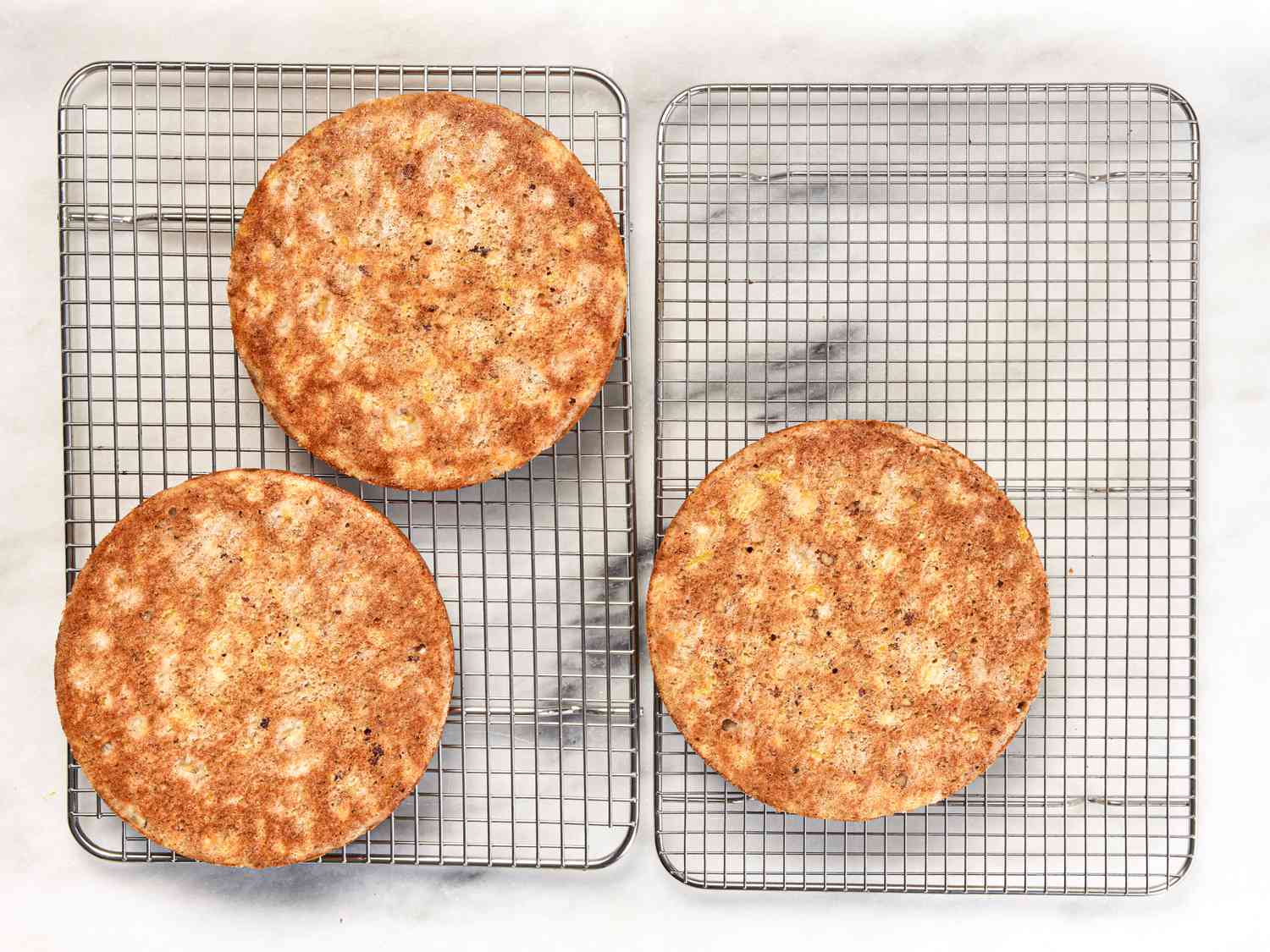 Cakes flipped onto cooking racks