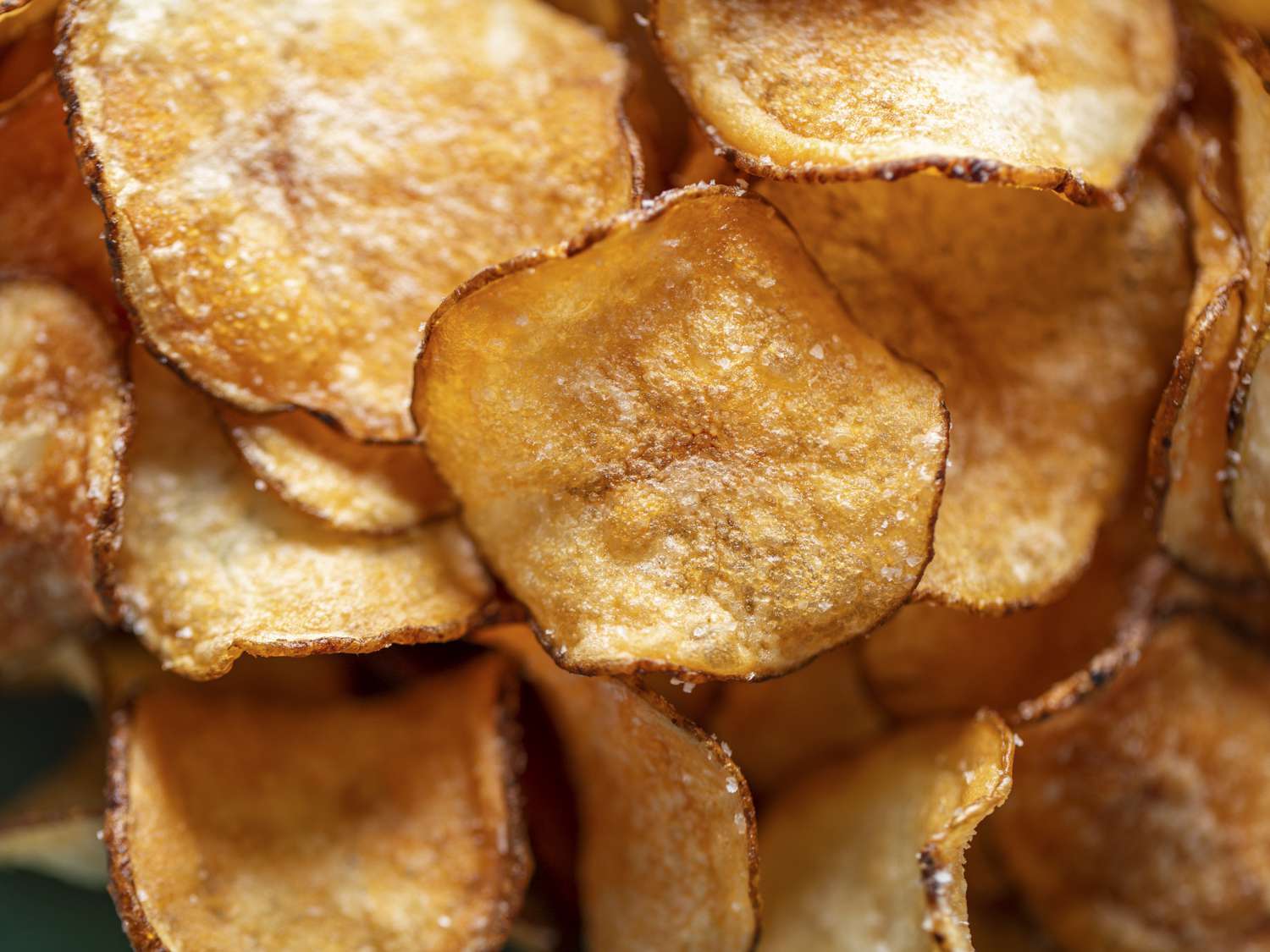 A close up of the fried and rested potato chips.