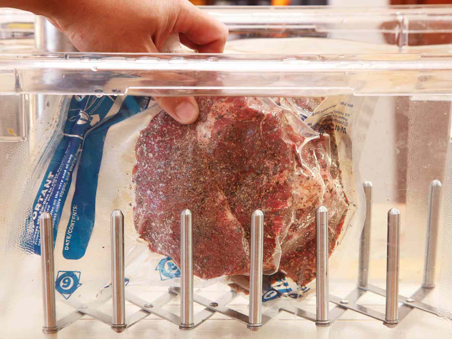 The bagged and seasoned chuck roast is submerged in water for cooking.