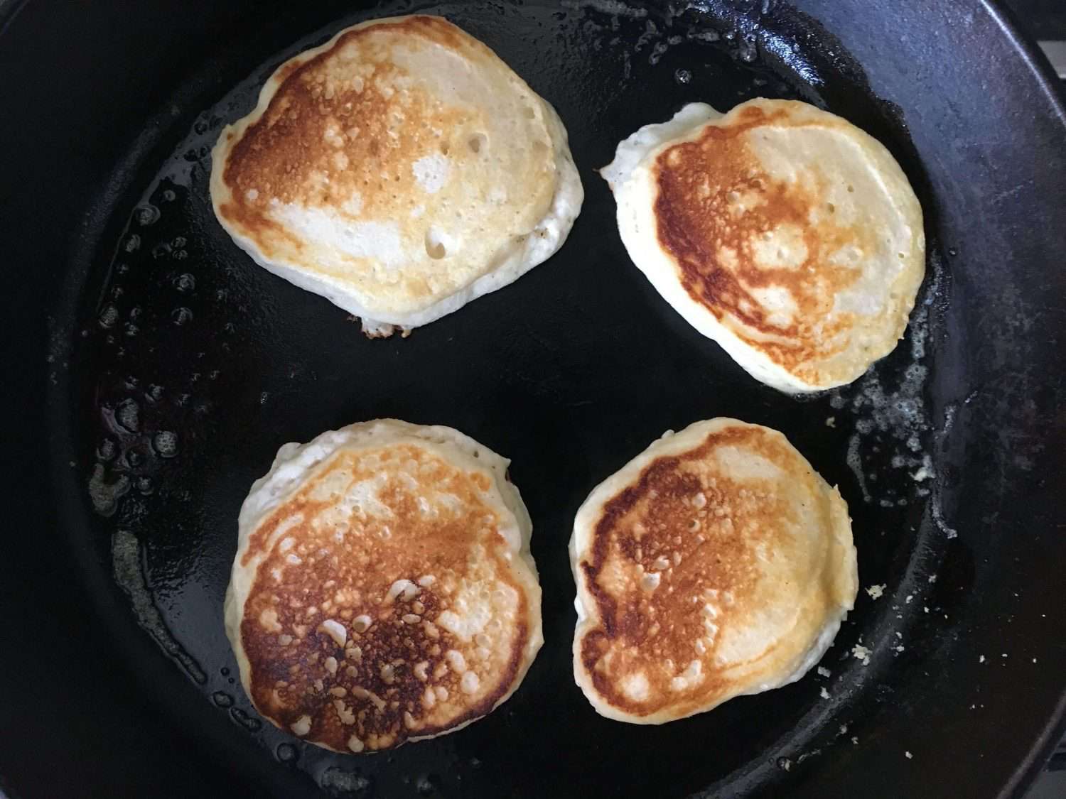 buttermilk pancakes cooking a cast iron pan