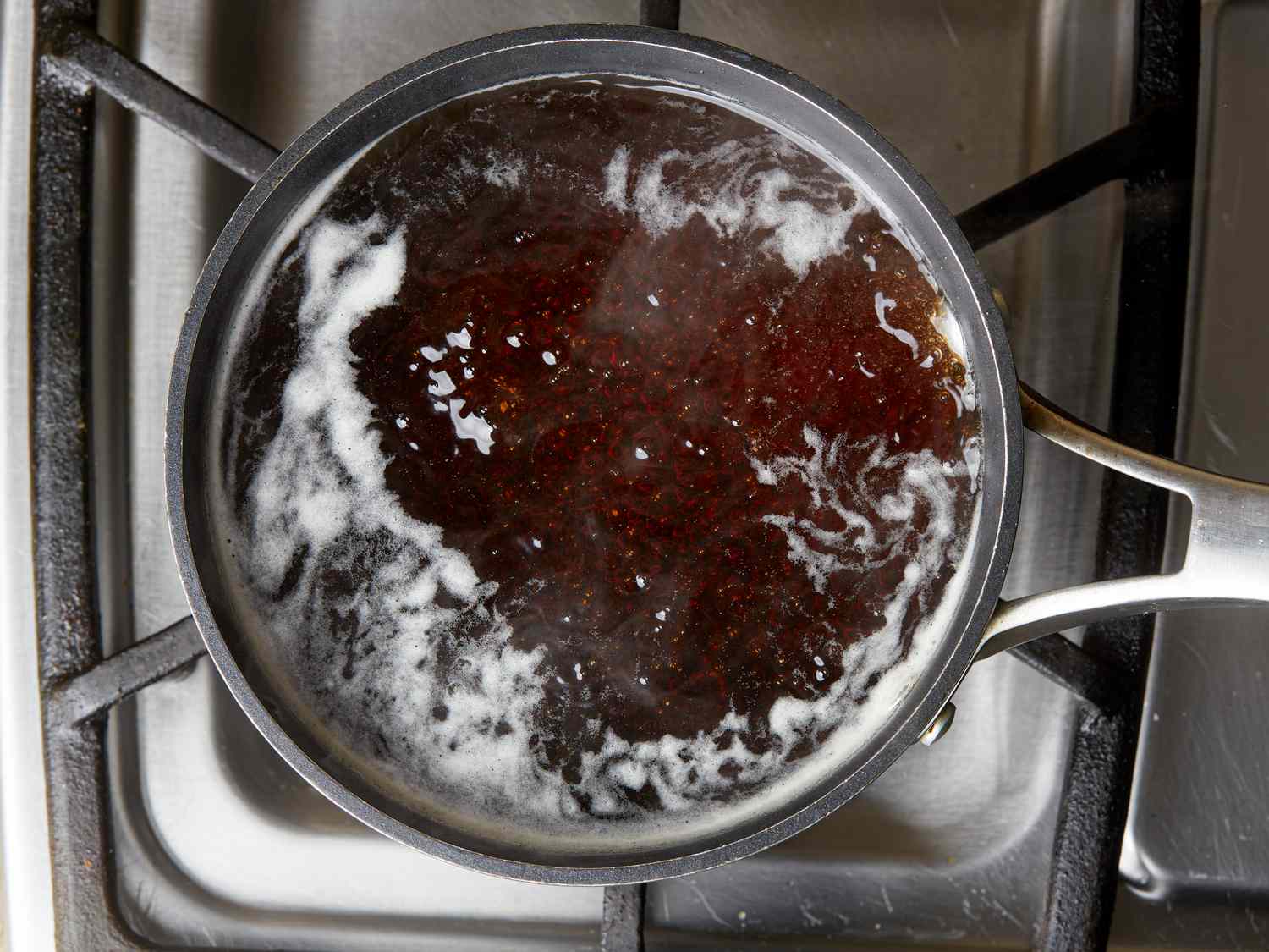 Overhead view of sauce boiling in pot