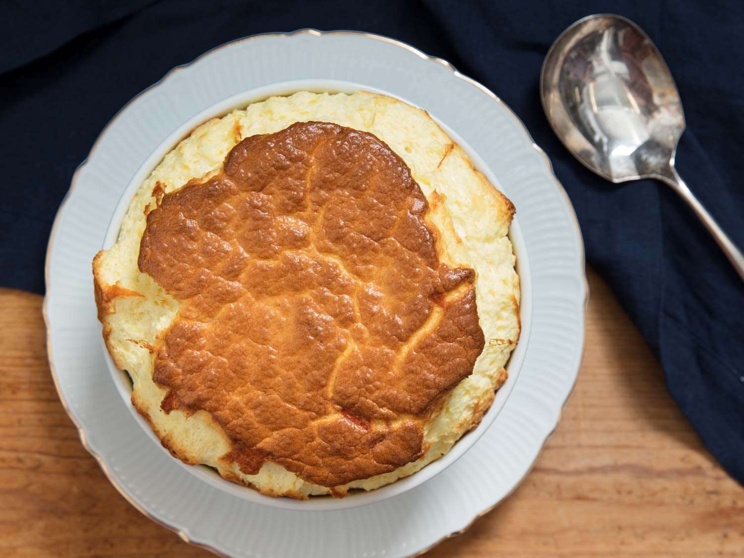 An overhead view of the browned top of a cheese soufflé.