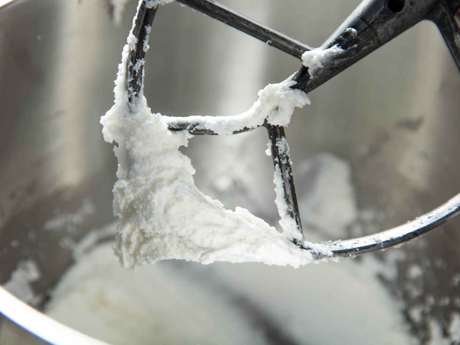 Lemon "creme" filling coats the beater of a stand mixer.