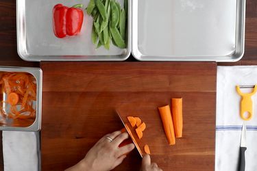 Overhead of a restaurant-inspired kitchen prep station for vegetables.