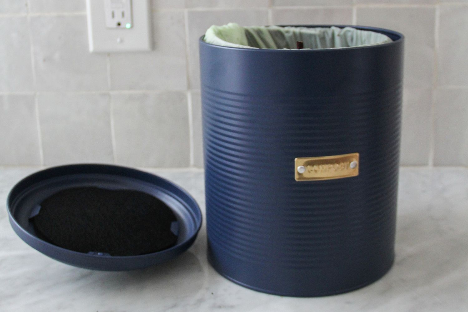 Typhoon compost caddy open on a counter
