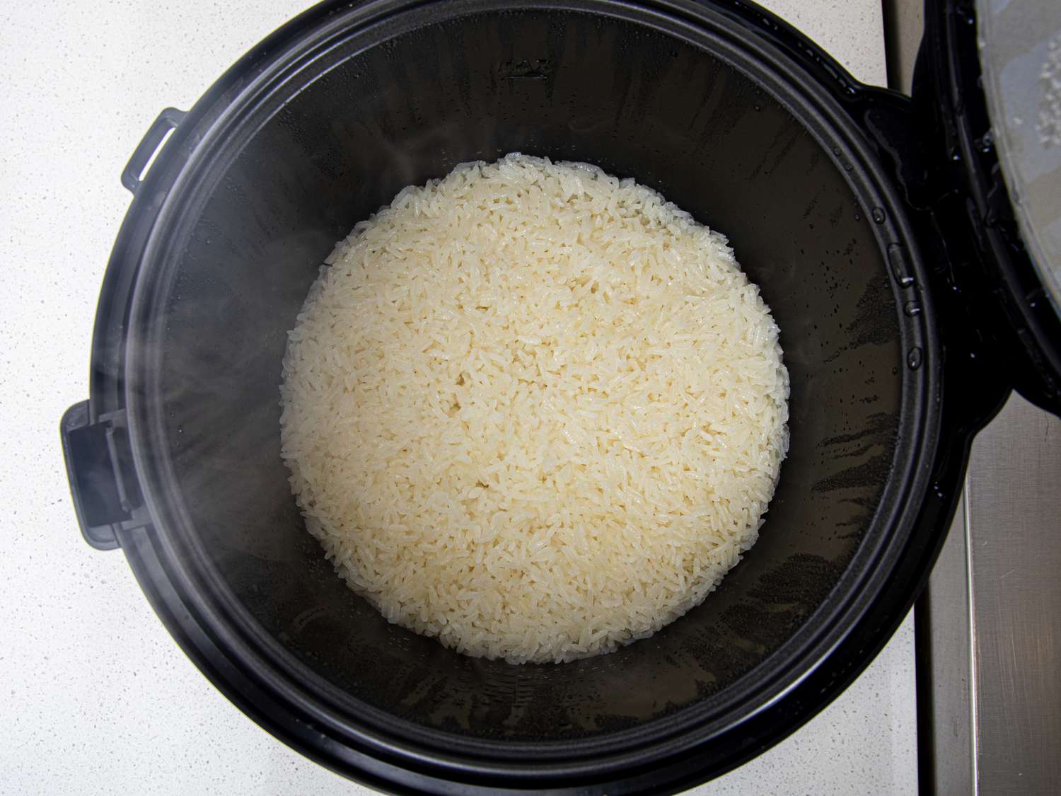 Overhead view of rice in a rice cooker