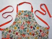  hexclad apron on a white tile surface