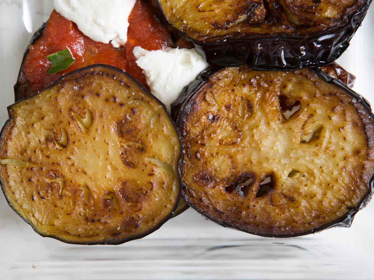 Slices of golden fried eggplant for Eggplant Parm.