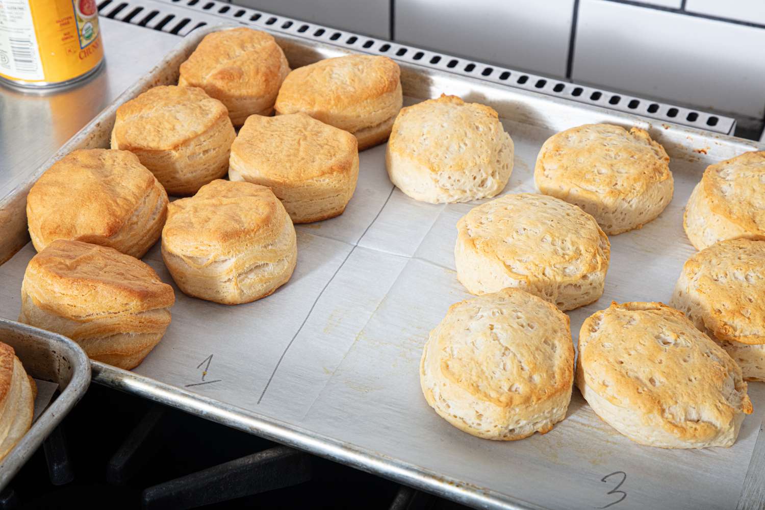 Three groups of baked biscuits numbered on parchment paper on a baking tray