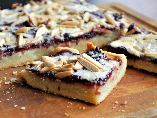 Closeup of blackberry bars on a wooden surface.