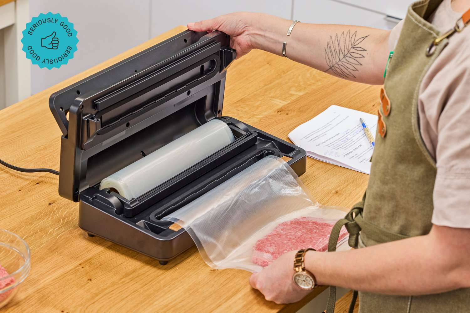  A person using an Anova vacuum sealer