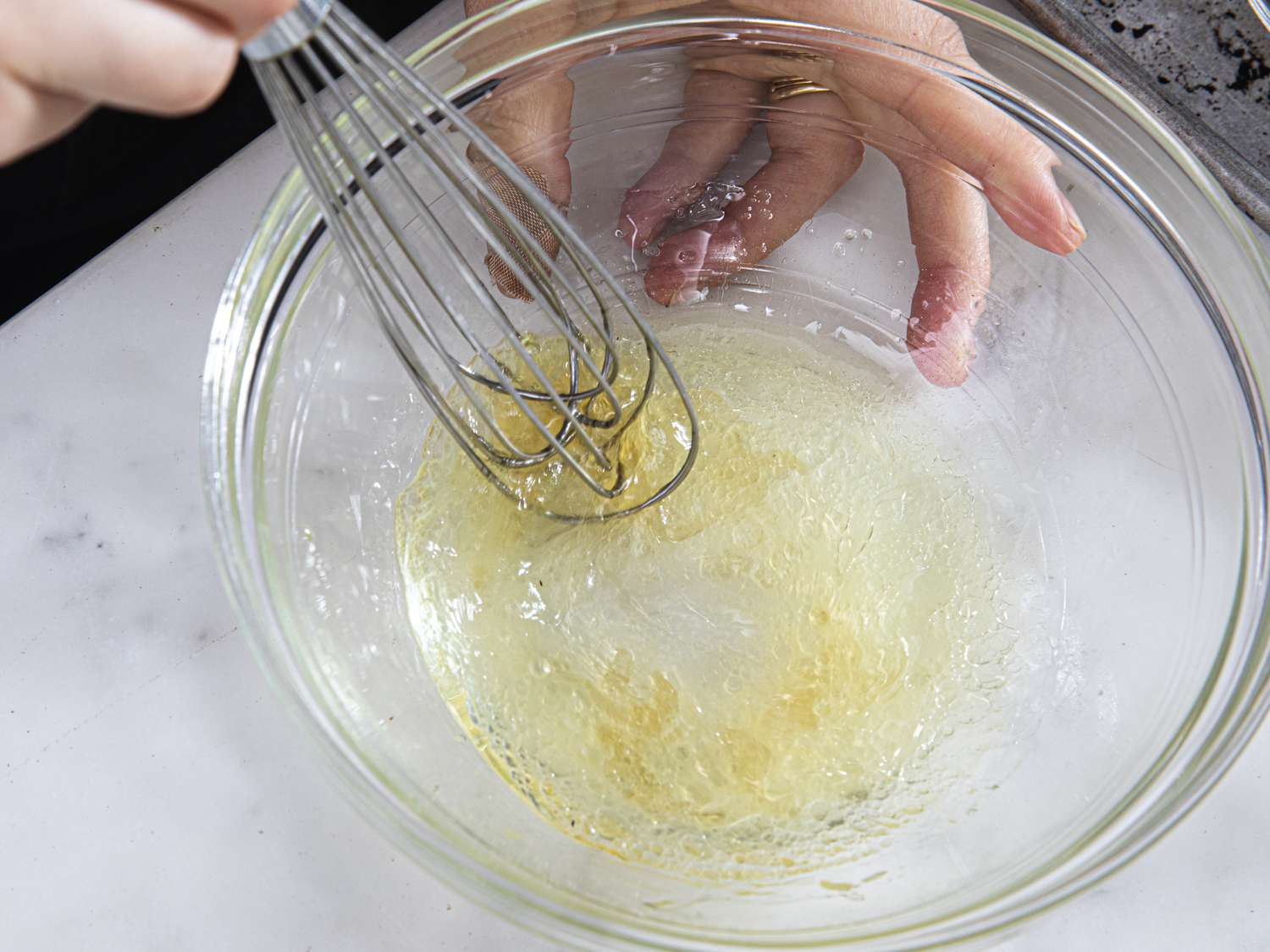 Whisking together lemon, and oil olive together