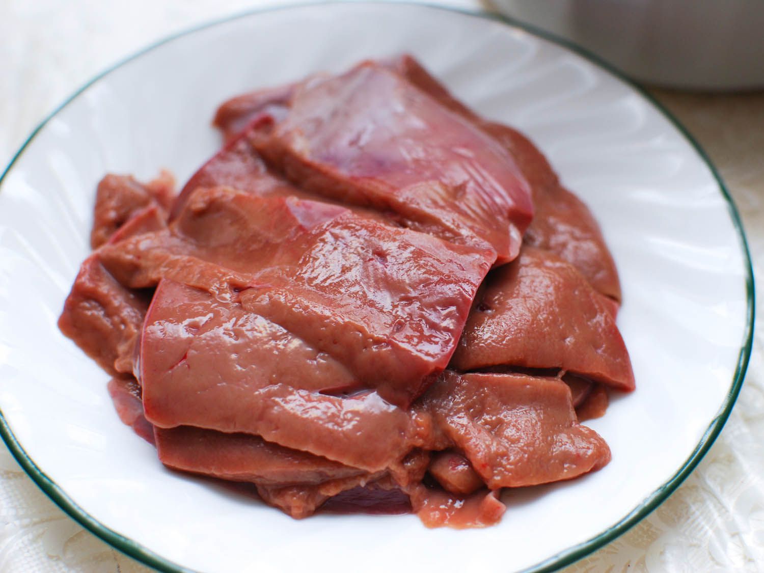 Pieces of liver on white plate for Chinese hot pot.