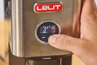 A person presses a button on the Lelit William Espresso Grinder