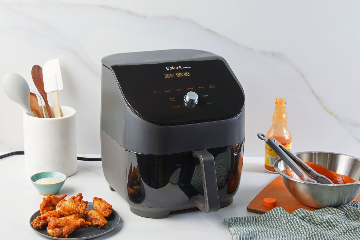 Instant Pot Vortex Plus 6-Quart ClearCook Air Fryer displayed on counter with cooked chicken and sauce