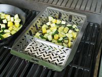 proud grill basket with chopped zucchini and summer squash