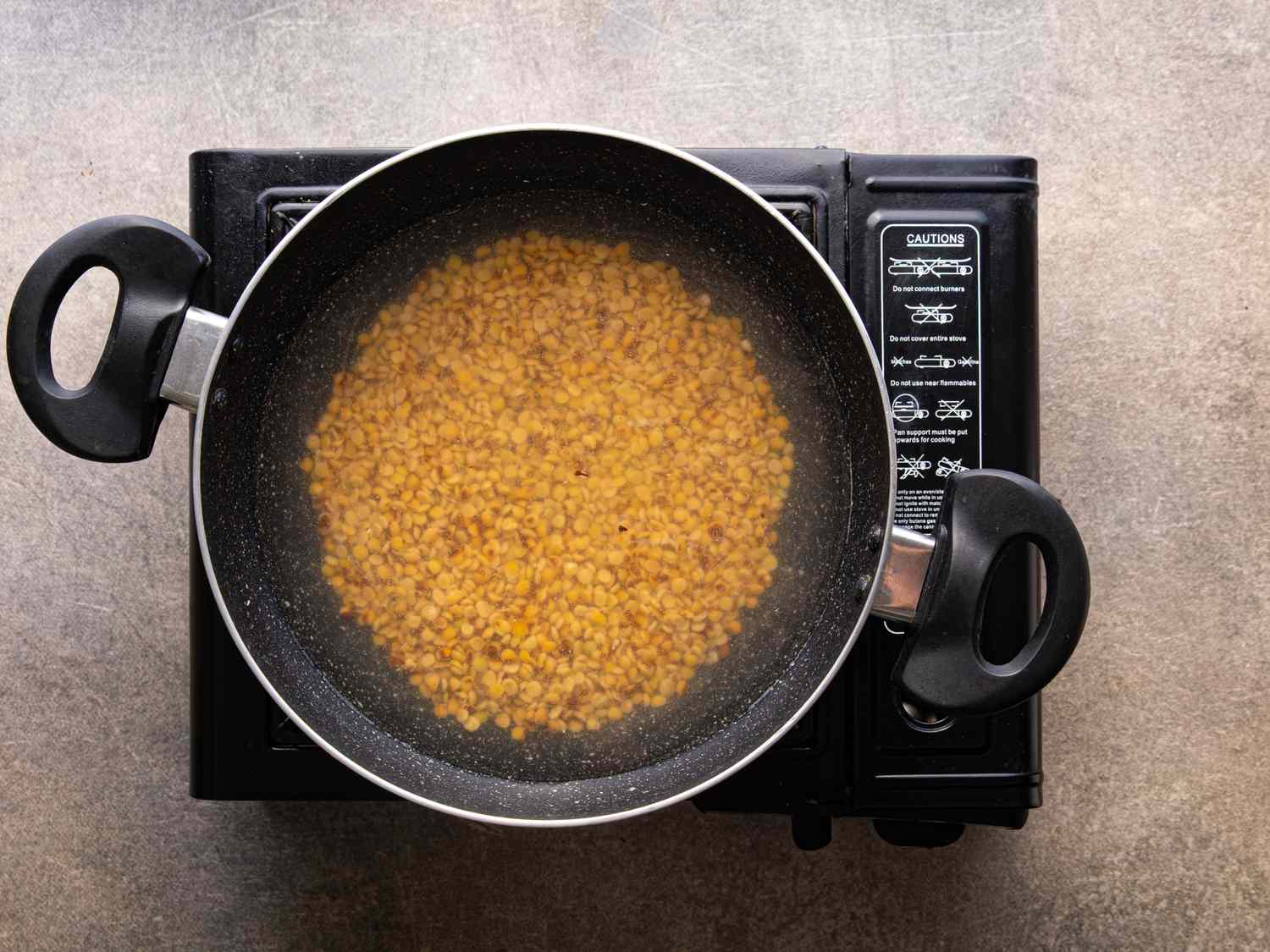 Cooking lentils in a pan on a stovetop