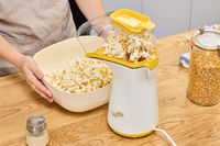 Popcorn is collected in a bowl after popping in the Presto Poplite Hot Air Popper