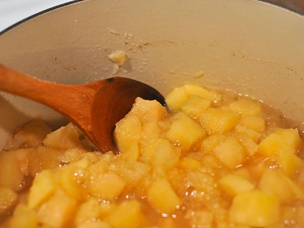 Chunks of apple are simmered in a Dutch oven