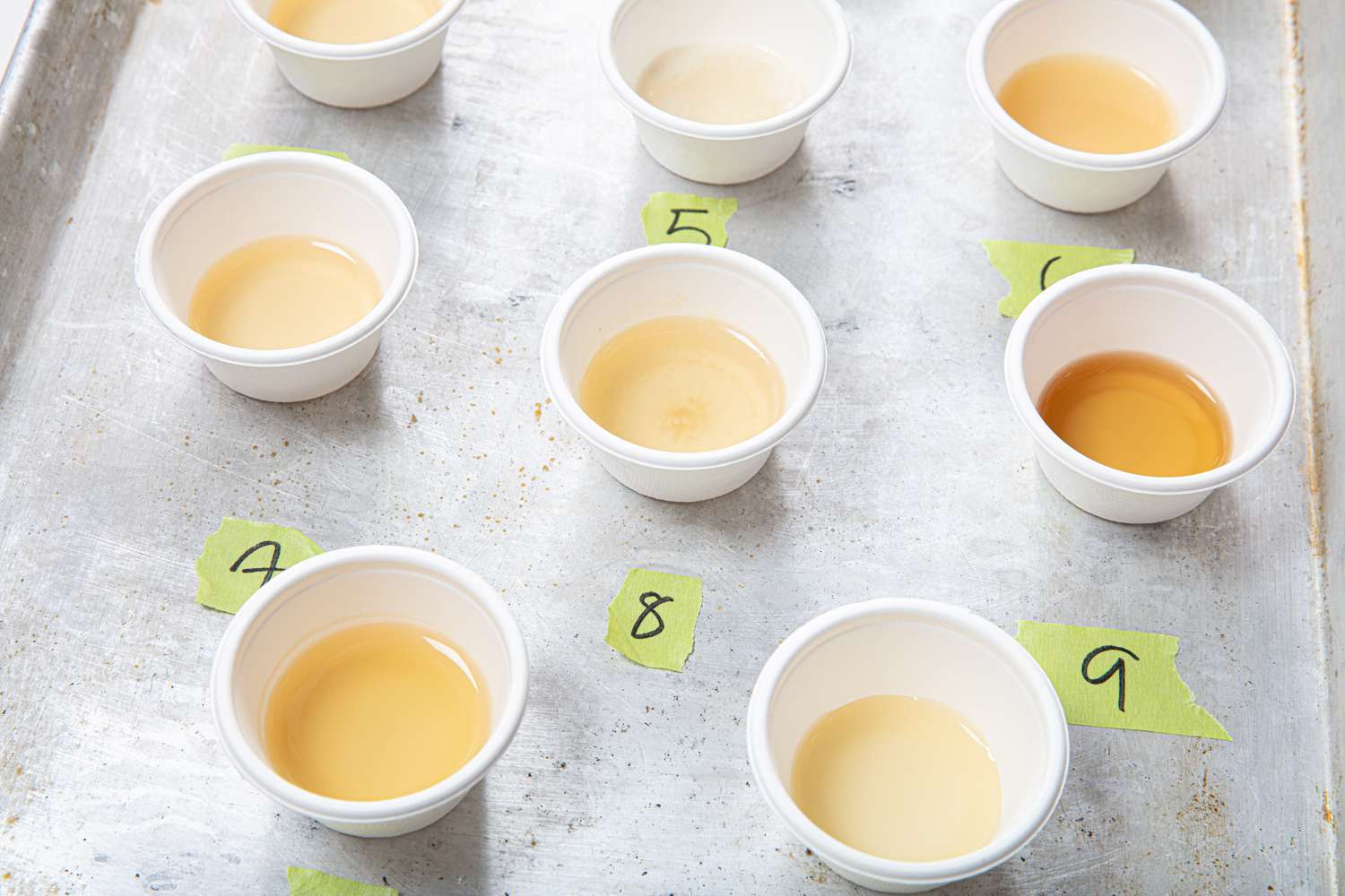 Overhead view of labeled chicken broth in tiny cups