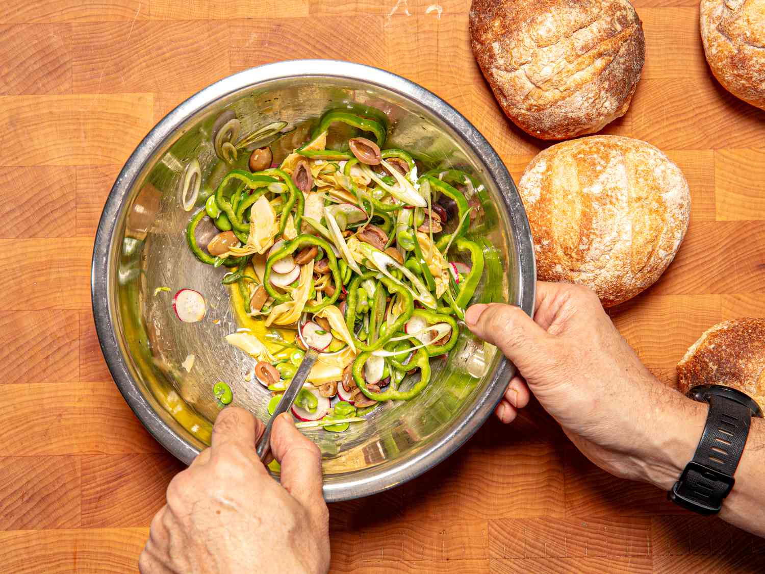 Overhead view of mixing toppings in a bowl