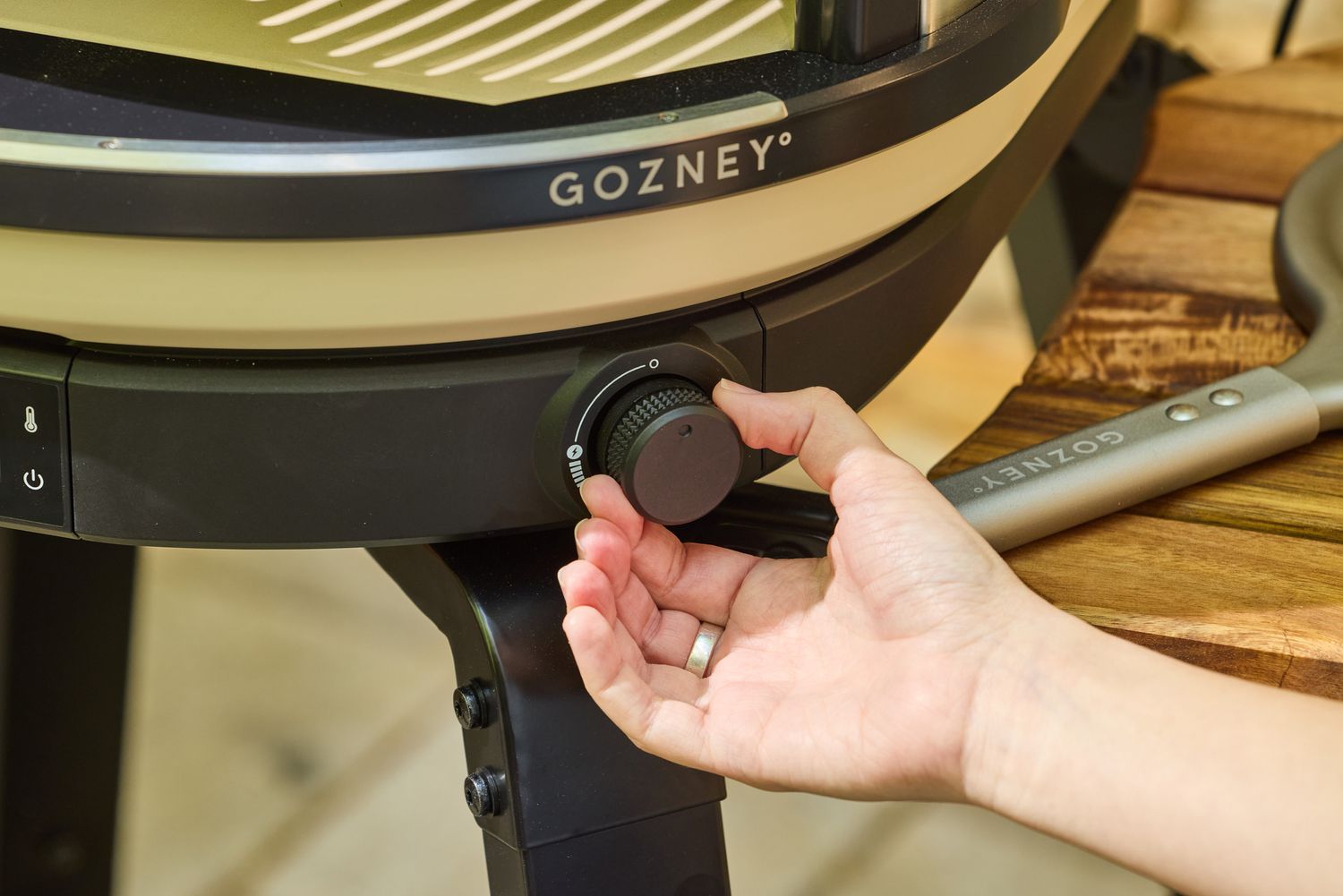 A person turns a dial on the Gozney ARC XL Compact Pizza Oven