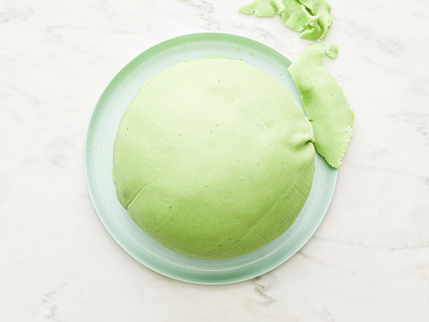 Round green cake covered in marzipan