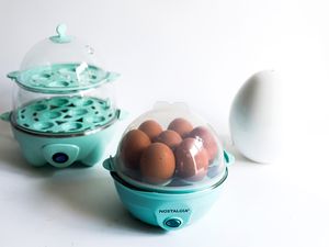 A collection of three egg cookers on a white background
