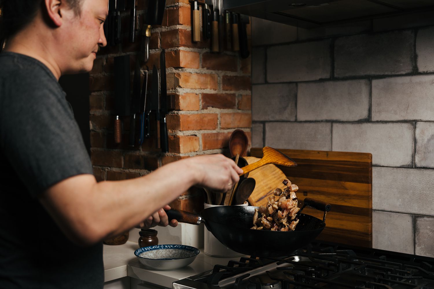 J. Kenji LÃ³pez-Alt stir-frying mussels in a wok