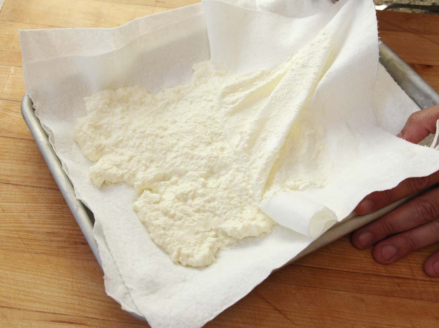 Draining ricotta between two layers of paper towel. 