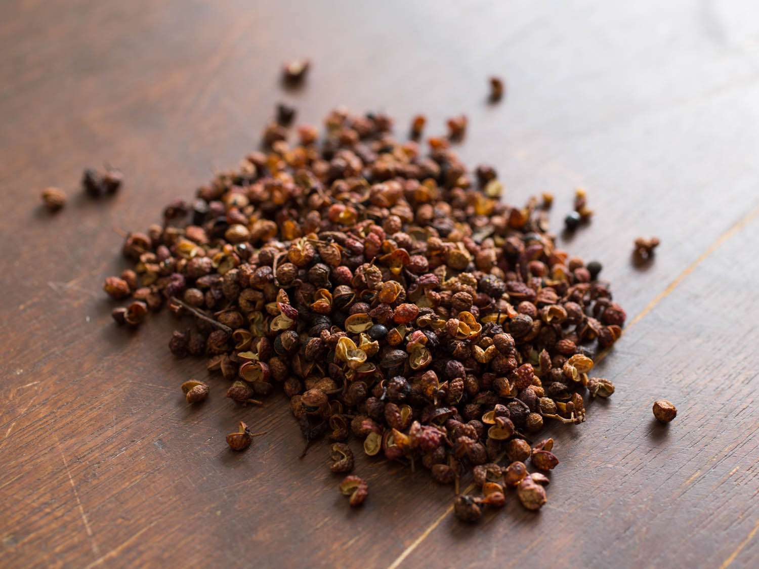 sichuan peppercorns on a wooden surface