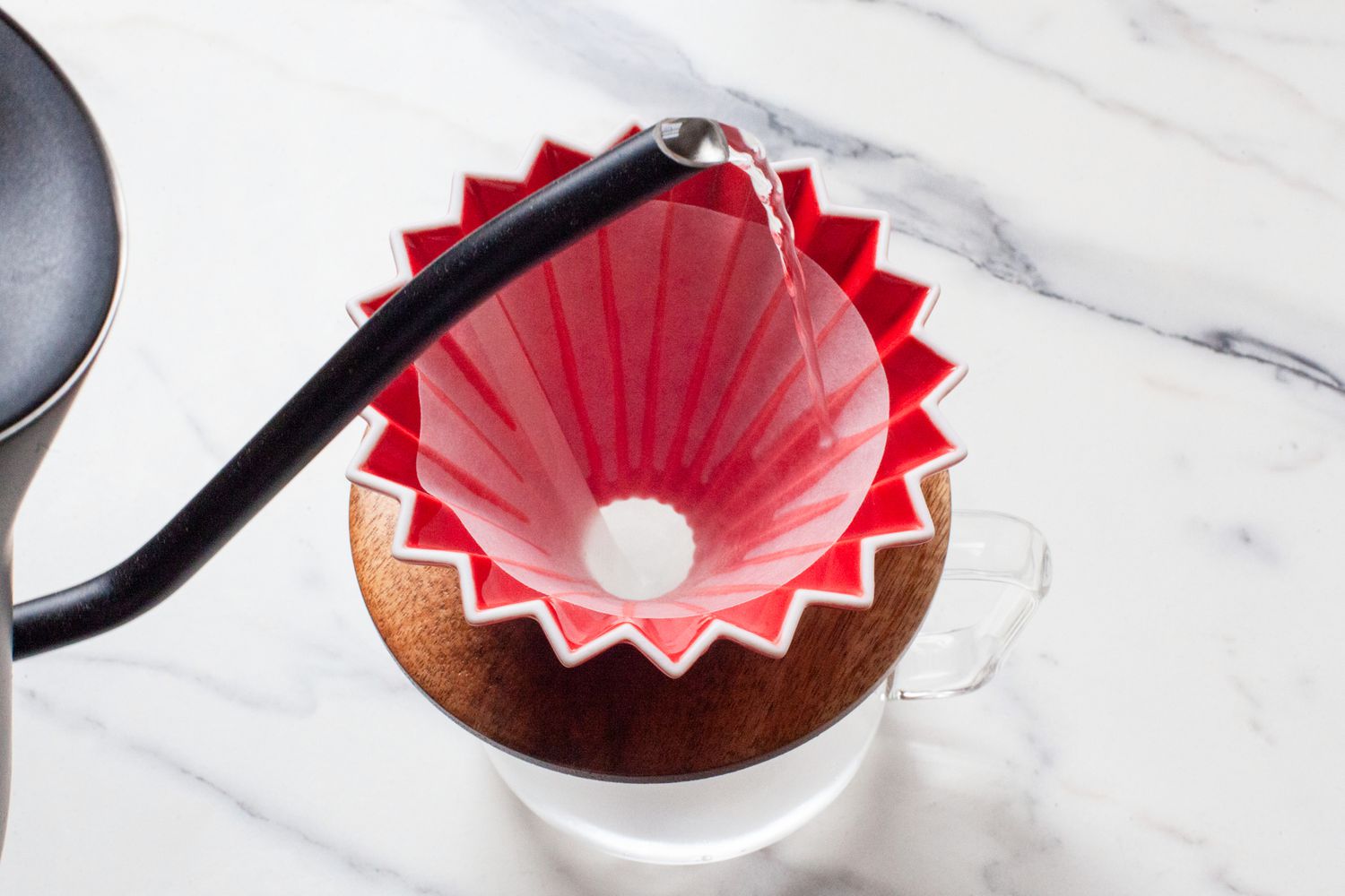 A kettle pouring water into the Origami dripper