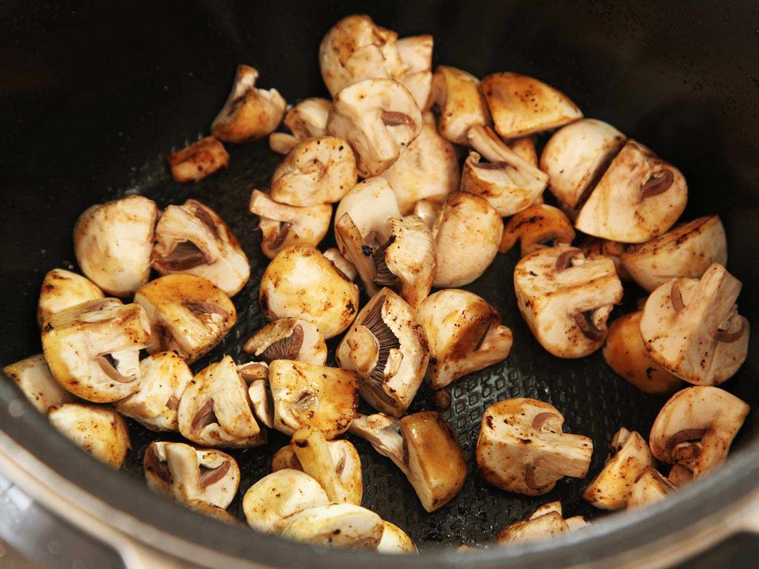 Mushrooms browning in a pressure cooker. 