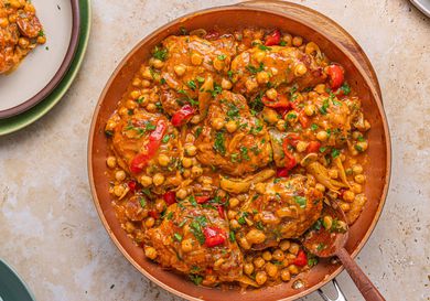 A skillet meal with chicken, chorizo, chickpeas, and vegetables