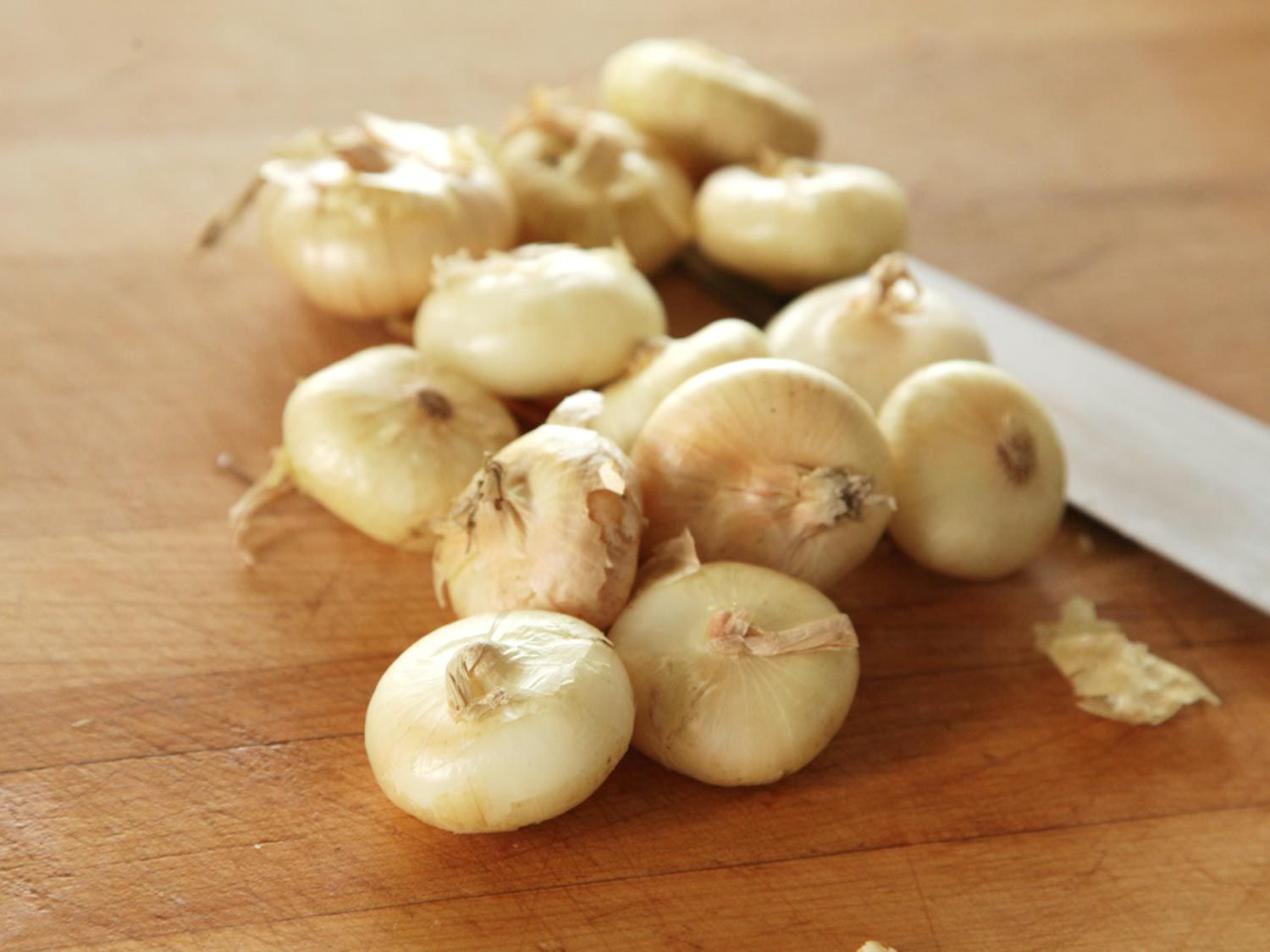 Raw, unpeeled cipollini onions.