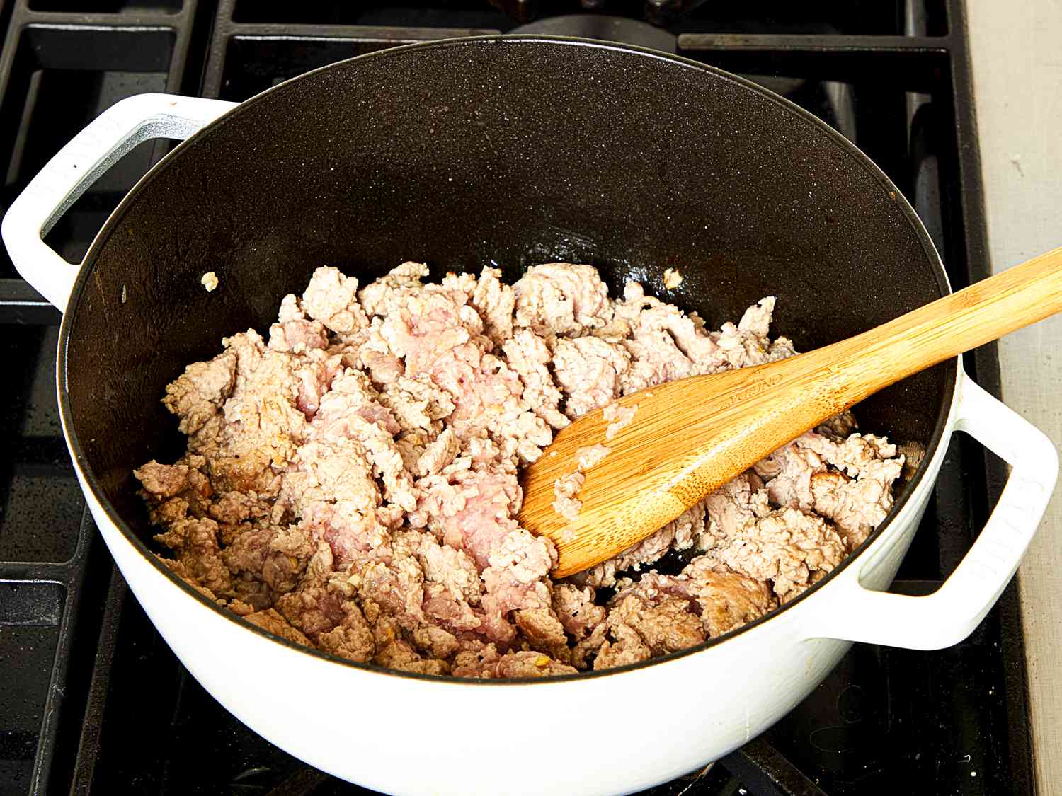 Pork cooking in pot on stovetop