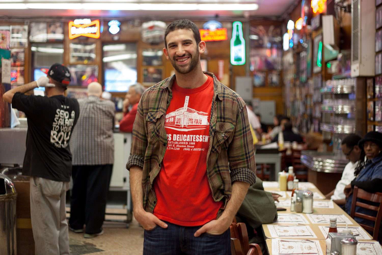 Jake Dell of Katz's posing in middle of restaurant.