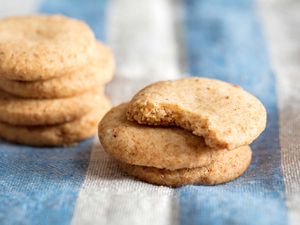 Short stacks of brown butter shortbread with one bite taken from first cookie