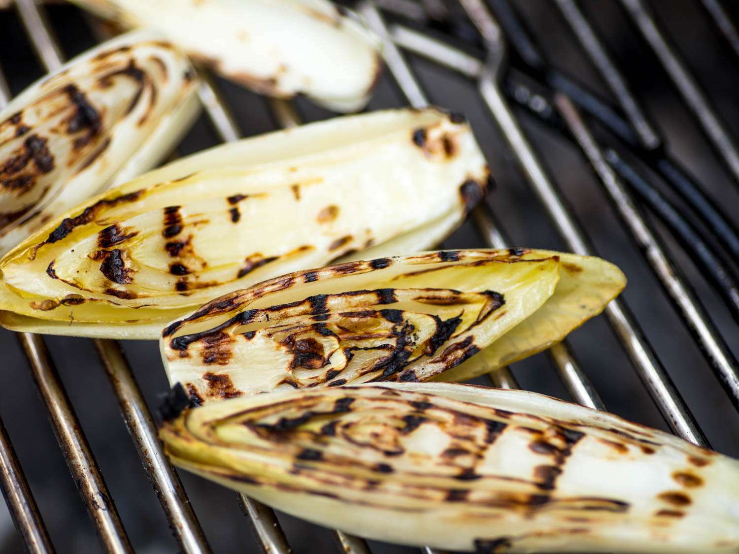 Endives on a grill grate. 