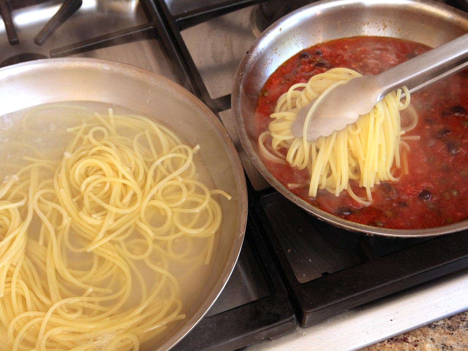 Transferring cooked spaghetti to a skillet of sauce for pasta puttanesca.