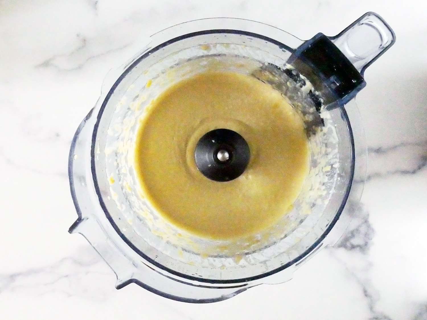 the vitamix blender holding freshly pureed hummus