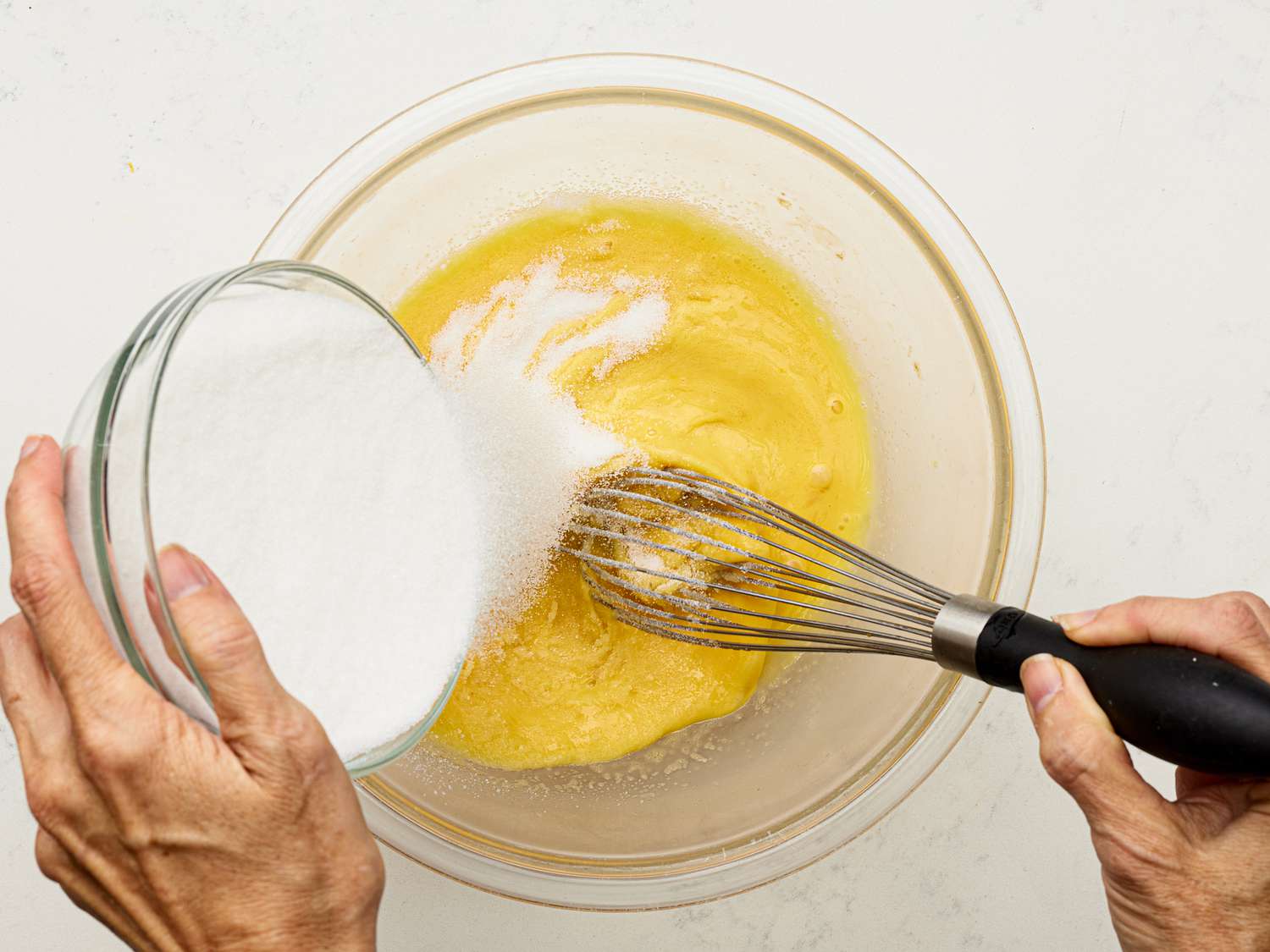 Overhead view of adding sugar to pie filling mixture