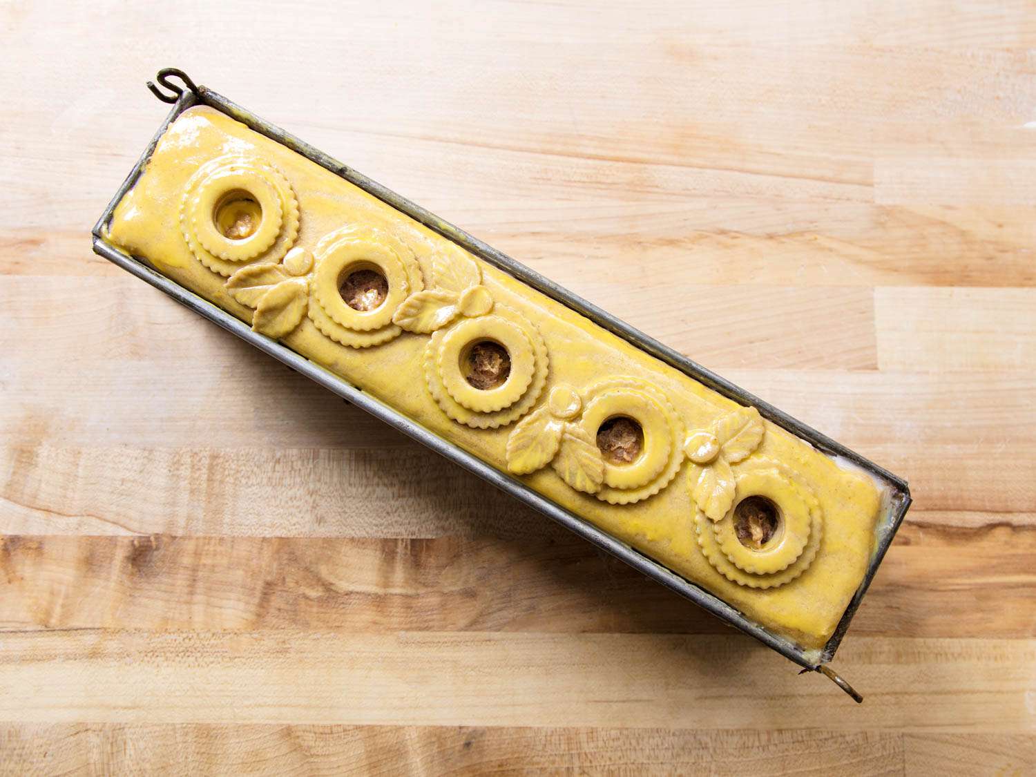 Overhead view of an assembled pâté en croûte, ready to be baked.