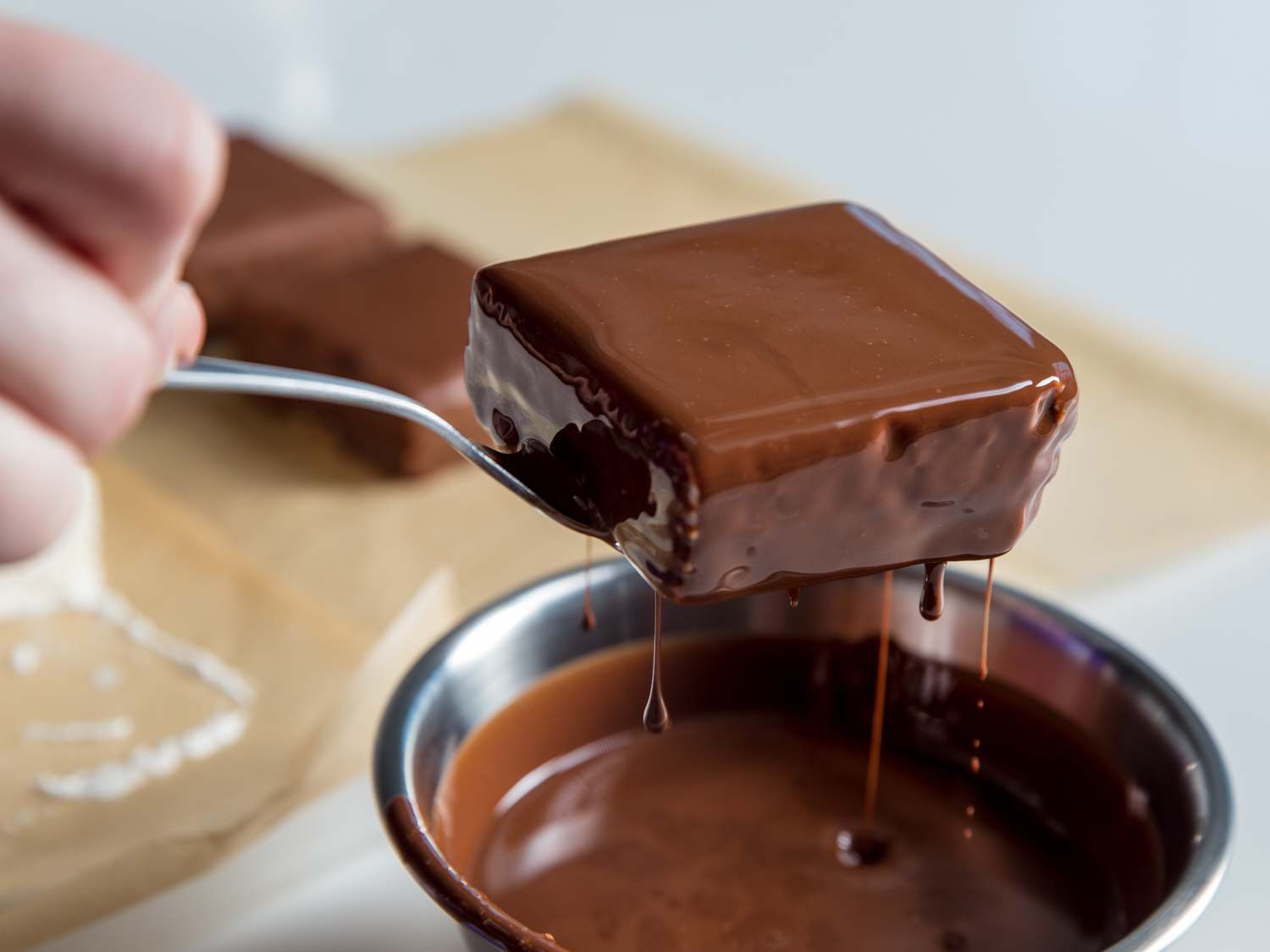 Milk chocolate dripping from a homemade Klondike Bar.
